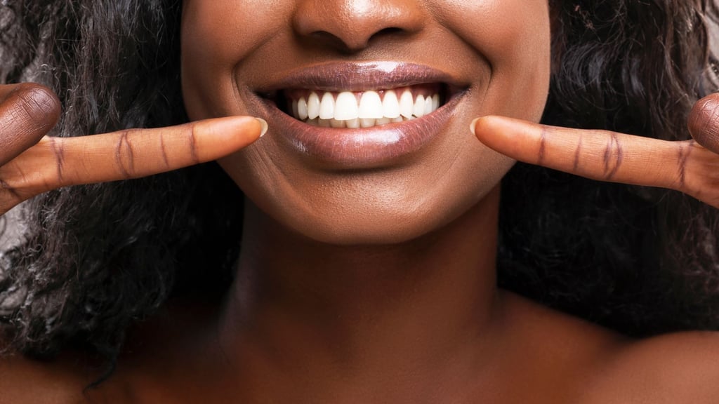 Smiling patient pointing at her bright teeth after composite bonding treatment at Smile Center Turkey