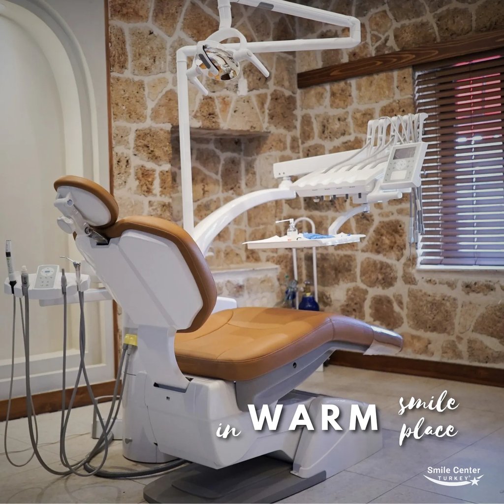 Warm-toned dental treatment room with stylish stone wall interior
