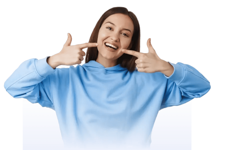 Happy patient pointing at her smile after cosmetic dental treatment at Smile Center Turkey