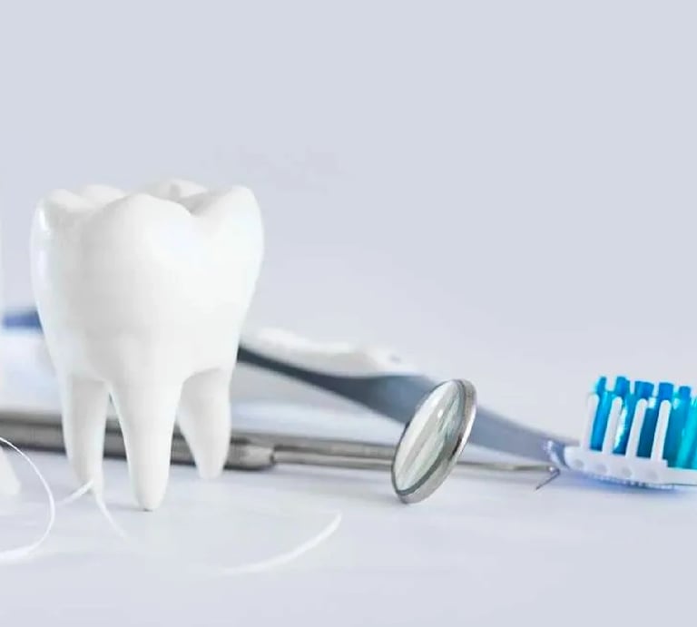 White tooth model with dental mirror and toothbrush representing laminate veneers healing process.