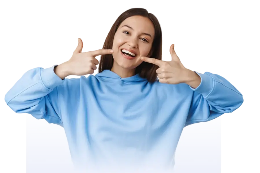 Happy patient pointing at her smile after cosmetic dental treatment at Smile Center Turkey